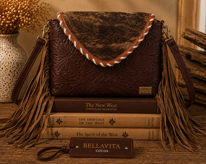 Bella Vita hand-tooled leather fringe shoulder bag in deep cocoa brown with brindle cowhide flap, whipstitch detail, long fringe, and brass longhorn badge