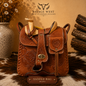Hand-tooled genuine leather saddlebag crossbody bag in tan brown with embossed floral leather, wooden horn and cantle, and turn-lock clasp - western cowhide handbag
